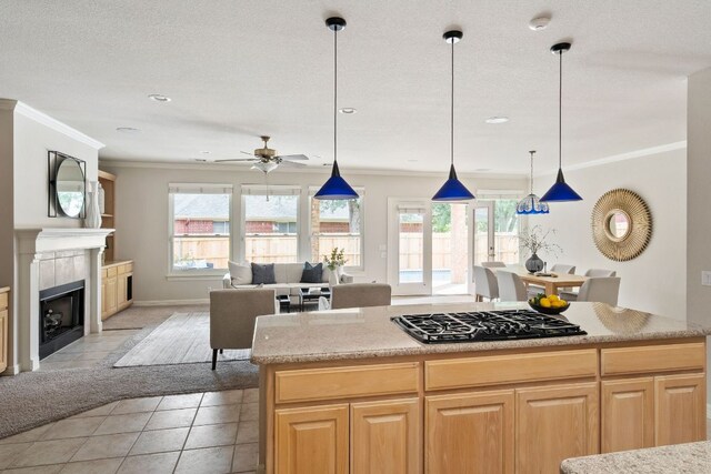 11037 River Plantation Dr, Austin, TX 78747 - kitchen featuring ornamental molding, a ceiling fan, light tile patterned floors, black gas cooktop, and light countertops