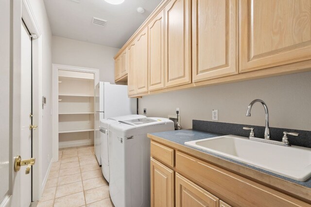 11037 River Plantation Dr, Austin, TX 78747 - laundry area with cabinet space, light tile patterned floors, and washer and dryer