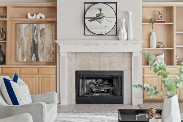 11037 River Plantation Dr, Austin, TX 78747 - living area with a tile fireplace, ceiling fan, light tile patterned flooring, and built in features