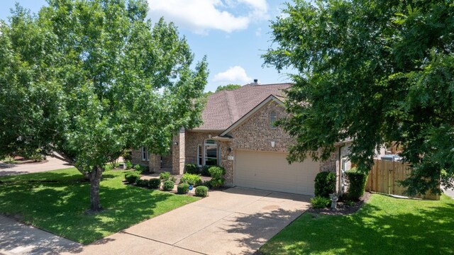 11037 River Plantation Dr, Austin, TX 78747 - view of property hidden behind natural elements with a garage, concrete driveway, and stone siding