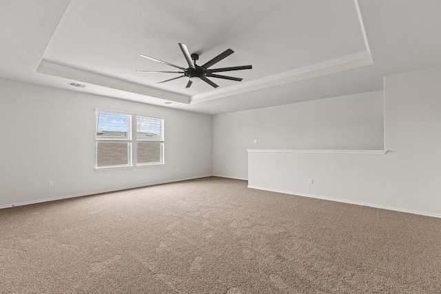 709 Hummingbird Ln, Leander, TX 78641 - carpeted spare room featuring a tray ceiling, a ceiling fan, and baseboards