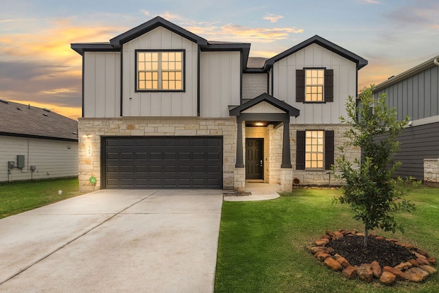 709 Hummingbird Ln, Leander, TX 78641 - view of front of property with board and batten siding, stone siding, a yard, and an attached garage