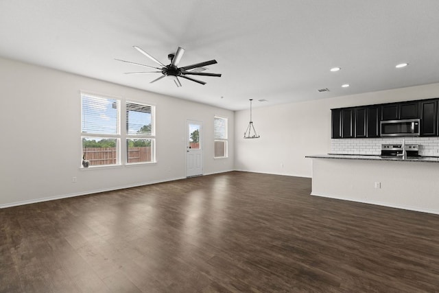 709 Hummingbird Ln, Leander, TX 78641 - unfurnished living room with ceiling fan, dark wood-style floors, recessed lighting, and baseboards