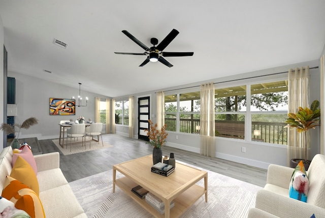 409 Lake View Dr, Spicewood, TX 78669 - living area featuring lofted ceiling, a chandelier, baseboards, light wood-style flooring, and ceiling fan