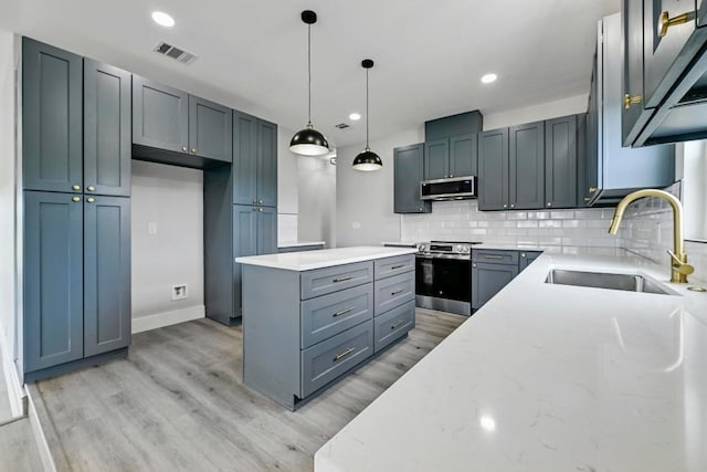 409 Lake View Dr, Spicewood, TX 78669 - kitchen with a sink, appliances with stainless steel finishes, light stone countertops, backsplash, and light wood-type flooring