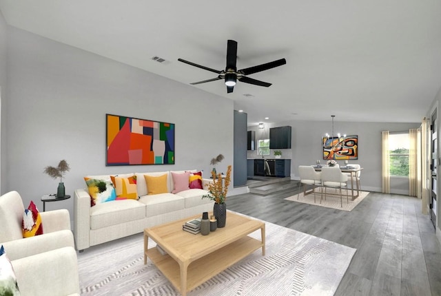 409 Lake View Dr, Spicewood, TX 78669 - living area featuring a chandelier, wood finished floors, ceiling fan, baseboards, and recessed lighting