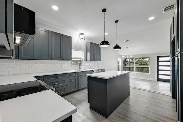 409 Lake View Dr, Spicewood, TX 78669 - kitchen with a sink, a kitchen island, tasteful backsplash, a chandelier, and recessed lighting