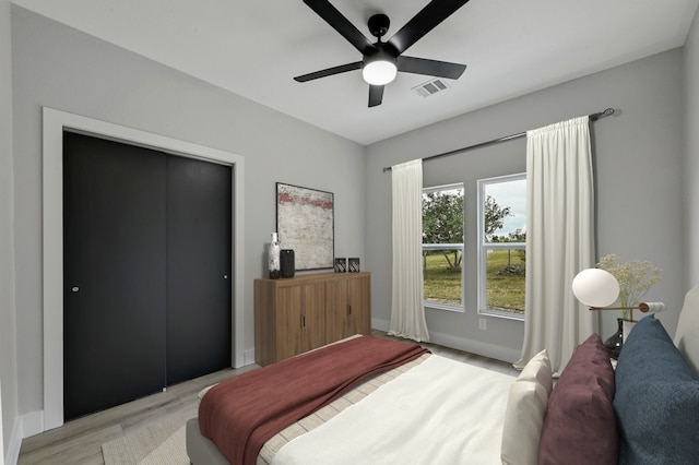 409 Lake View Dr, Spicewood, TX 78669 - bedroom with light wood finished floors, a ceiling fan, and baseboards