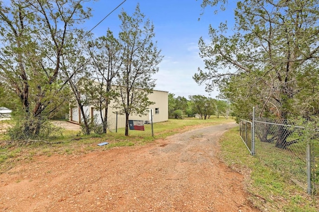 409 Lake View Dr, Spicewood, TX 78669 - view of dirt / gravel driveway featuring a gated entry