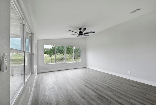 409 Lake View Dr, Spicewood, TX 78669 - empty room with wood finished floors, a ceiling fan, baseboards, and lofted ceiling