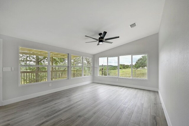 409 Lake View Dr, Spicewood, TX 78669 - unfurnished sunroom featuring baseboards, wood finished floors, and vaulted ceiling