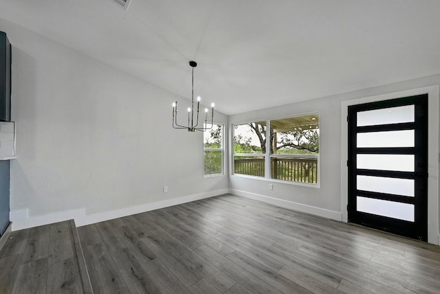 409 Lake View Dr, Spicewood, TX 78669 - unfurnished dining area with a chandelier, baseboards, wood finished floors, and lofted ceiling