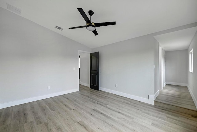 409 Lake View Dr, Spicewood, TX 78669 - spare room with a ceiling fan, light wood finished floors, vaulted ceiling, and baseboards