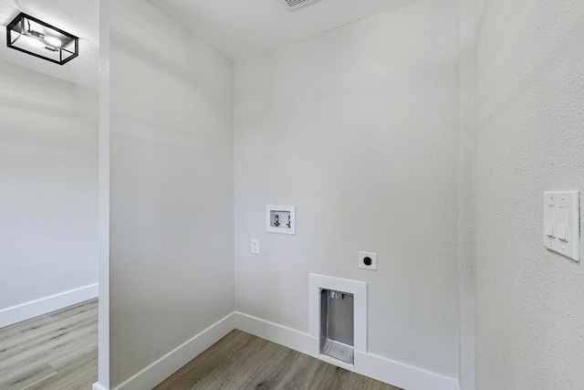 409 Lake View Dr, Spicewood, TX 78669 - washroom featuring washer hookup, wood finished floors, electric dryer hookup, and baseboards