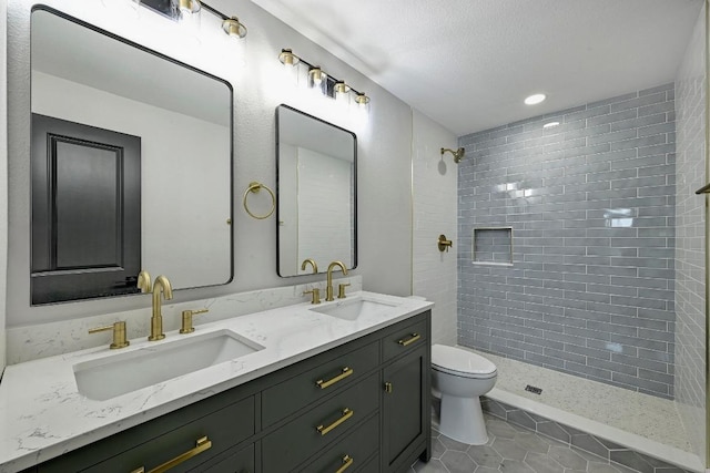 409 Lake View Dr, Spicewood, TX 78669 - full bath with toilet, double vanity, tile patterned floors, tiled shower, and recessed lighting