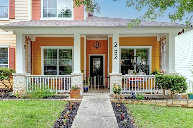 252 Hutton, Kyle, TX 78640 - doorway to property featuring a porch and a shingled roof