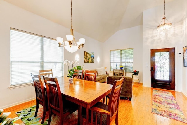252 Hutton, Kyle, TX 78640 - dining area featuring a chandelier, healthy amount of natural light, light wood finished floors, and high vaulted ceiling