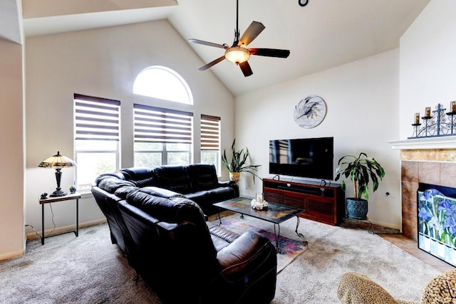 252 Hutton, Kyle, TX 78640 - living room featuring high vaulted ceiling, a ceiling fan, a tiled fireplace, and carpet flooring