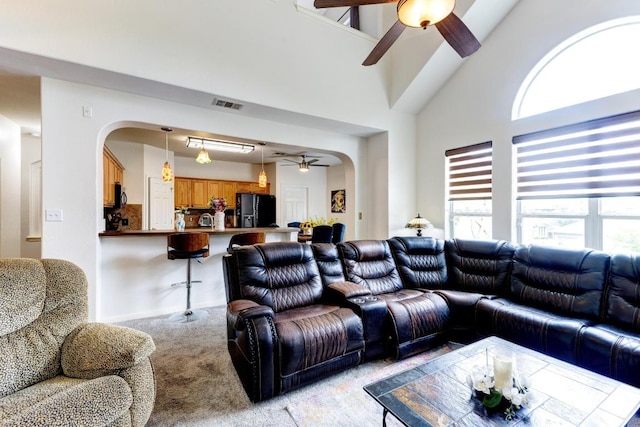252 Hutton, Kyle, TX 78640 - living area with ceiling fan, arched walkways, healthy amount of natural light, and light carpet