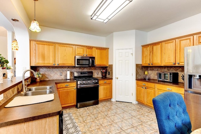 252 Hutton, Kyle, TX 78640 - kitchen featuring appliances with stainless steel finishes, a sink, arched walkways, dark countertops, and decorative backsplash