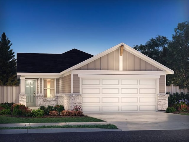 12901 Brave Tenderfoot Trl, Austin, TX 78610 - view of front of property with stone siding, an attached garage, driveway, and board and batten siding