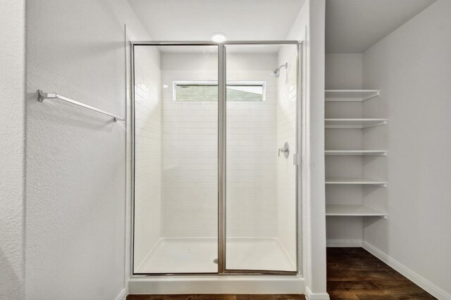 210 Briggs Ln, San Marcos, TX 78666 - full bath featuring a shower stall, wood finished floors, and baseboards