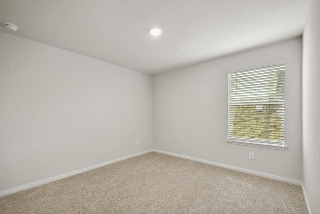 210 Briggs Ln, San Marcos, TX 78666 - spare room with a smoke detector, carpet flooring, and baseboards