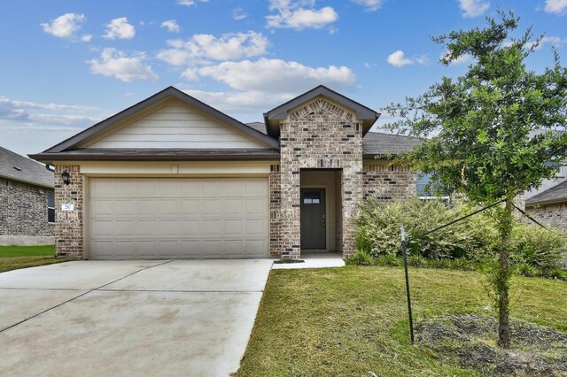 210 Briggs Ln, San Marcos, TX 78666 - view of front of home with an attached garage, concrete driveway, a front lawn, brick siding, and stone siding