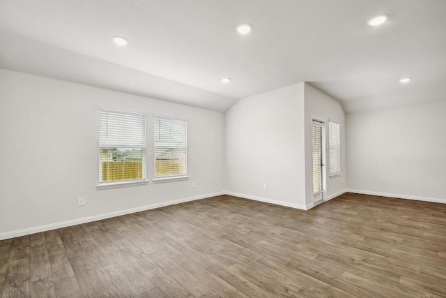 210 Briggs Ln, San Marcos, TX 78666 - unfurnished room featuring wood finished floors, recessed lighting, lofted ceiling, and baseboards
