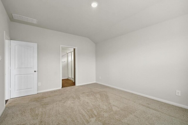 210 Briggs Ln, San Marcos, TX 78666 - unfurnished bedroom featuring carpet flooring, baseboards, and vaulted ceiling