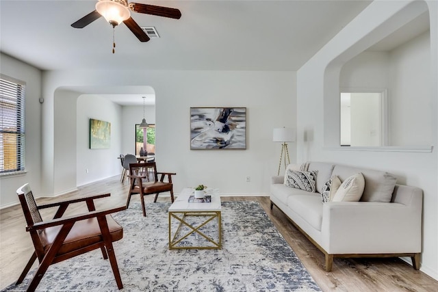 14605 Naruna Way, Pflugerville, TX 78660 - living area with healthy amount of natural light, ceiling fan, arched walkways, and wood finished floors