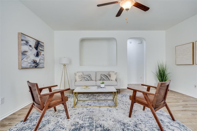 14605 Naruna Way, Pflugerville, TX 78660 - living room with wood finished floors, ceiling fan, arched walkways, and baseboards