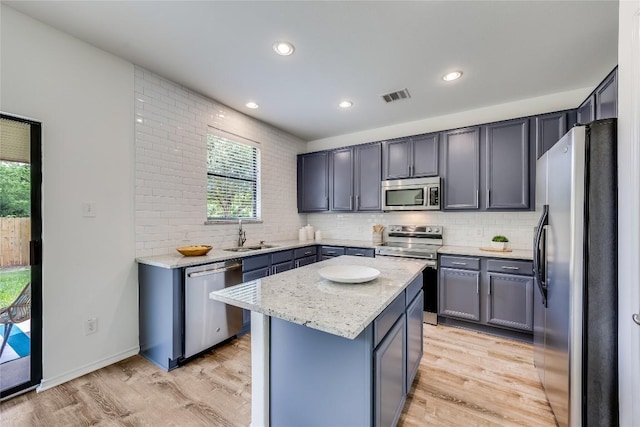 14605 Naruna Way, Pflugerville, TX 78660 - kitchen featuring appliances with stainless steel finishes, plenty of natural light, a sink, backsplash, and recessed lighting