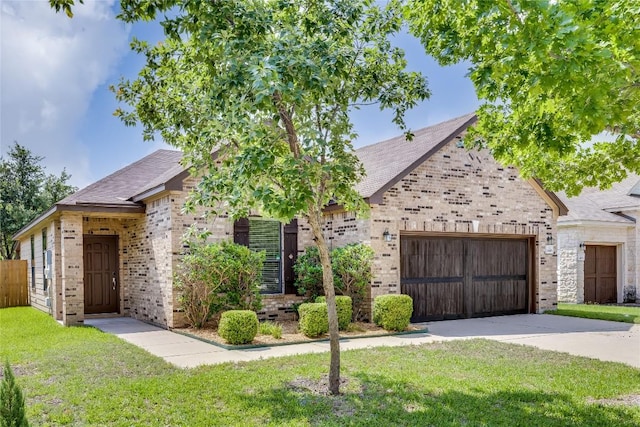 14605 Naruna Way, Pflugerville, TX 78660 - view of front facade featuring brick siding, a garage, driveway, a front yard, and roof with shingles