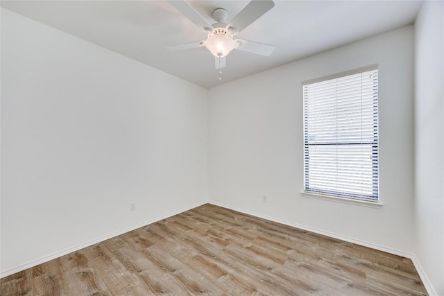 14605 Naruna Way, Pflugerville, TX 78660 - empty room with wood finished floors, plenty of natural light, and baseboards