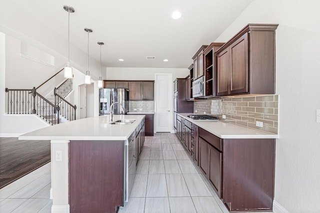 505 Fair Oaks Dr, Georgetown, TX 78628 - kitchen featuring a sink, appliances with stainless steel finishes, tasteful backsplash, light countertops, and decorative light fixtures