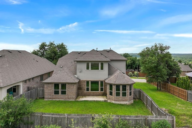 505 Fair Oaks Dr, Georgetown, TX 78628 - back of house with brick siding, a shingled roof, and a patio