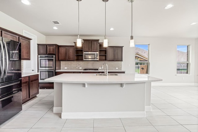 505 Fair Oaks Dr, Georgetown, TX 78628 - kitchen featuring appliances with stainless steel finishes, open shelves, a sink, light countertops, and backsplash