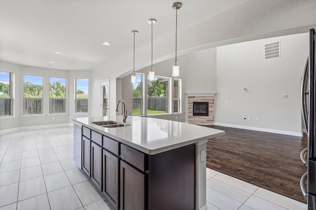 505 Fair Oaks Dr, Georgetown, TX 78628 - kitchen with open floor plan, a sink, dishwasher, light tile patterned floors, and recessed lighting