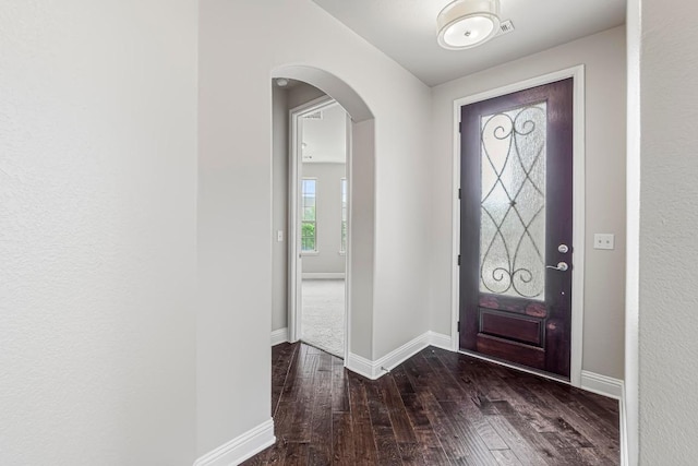 505 Fair Oaks Dr, Georgetown, TX 78628 - foyer entrance featuring hardwood / wood-style floors, arched walkways, and baseboards