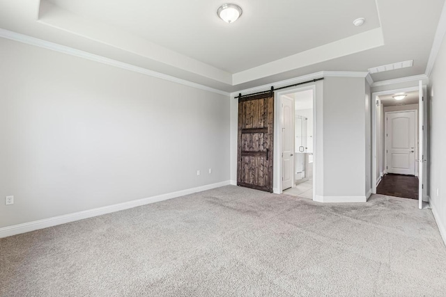 505 Fair Oaks Dr, Georgetown, TX 78628 - unfurnished bedroom featuring a tray ceiling, light carpet, baseboards, ornamental molding, and a barn door