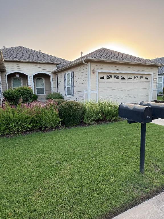 127 Nassau Cir, Georgetown, TX 78633 - view of front facade featuring a garage, a front lawn, and driveway