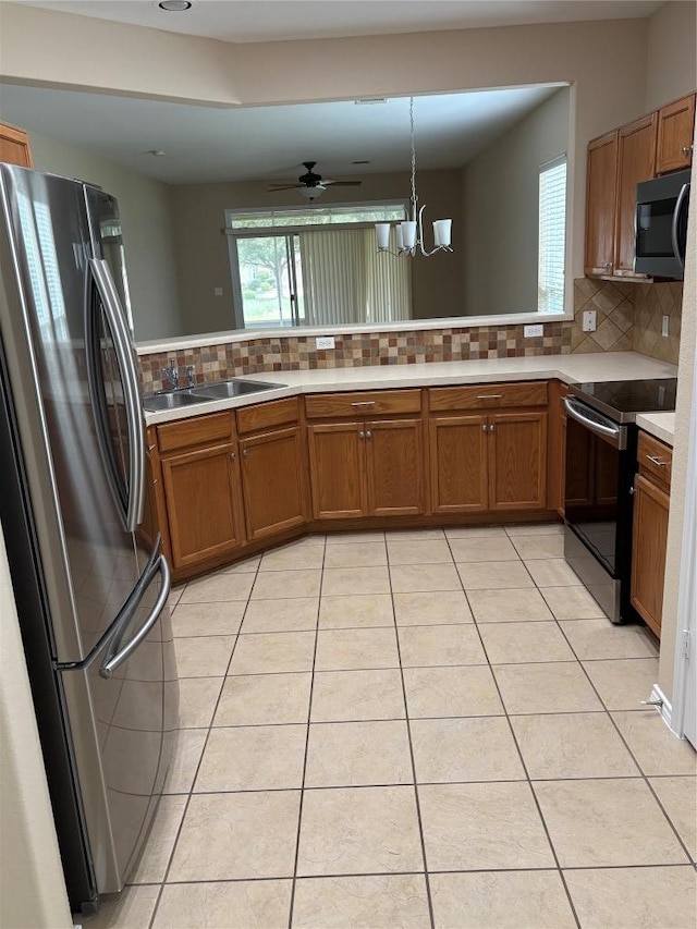 127 Nassau Cir, Georgetown, TX 78633 - kitchen with stainless steel appliances, brown cabinets, and tasteful backsplash