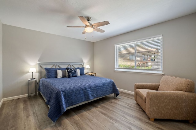 515 Circle Dr, Sunrise Beach, TX 78643 - bedroom with baseboards, wood finished floors, and ceiling fan
