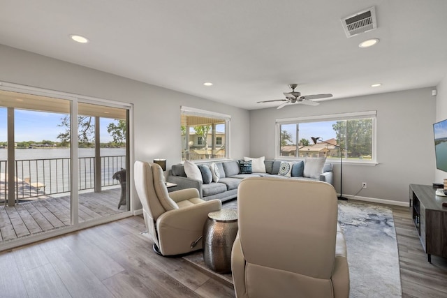 515 Circle Dr, Sunrise Beach, TX 78643 - living area featuring a water view, ceiling fan, wood finished floors, recessed lighting, and baseboards