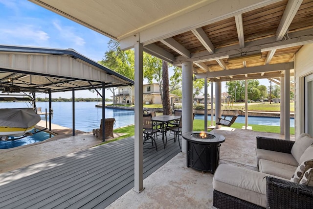 515 Circle Dr, Sunrise Beach, TX 78643 - view of patio / terrace with boat lift, a fire pit, a water view, and a dock