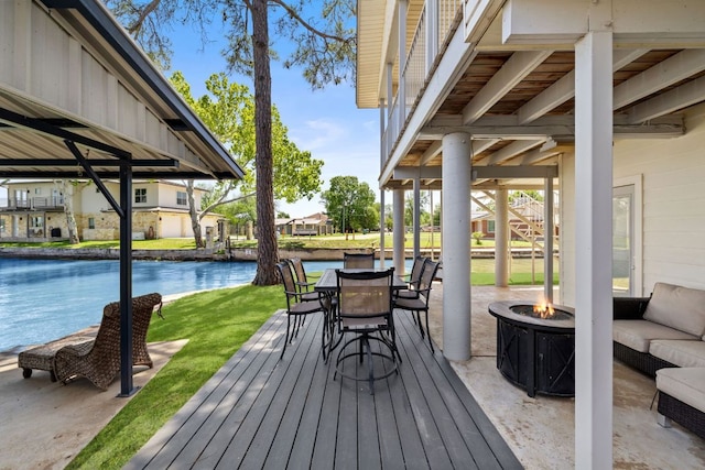 515 Circle Dr, Sunrise Beach, TX 78643 - deck featuring an outdoor fire pit, a lawn, a water view, and stairway