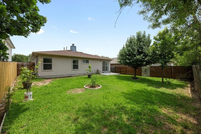 3807 Haleys Way, Round Rock, TX 78665 - back of house with a fenced backyard and a chimney