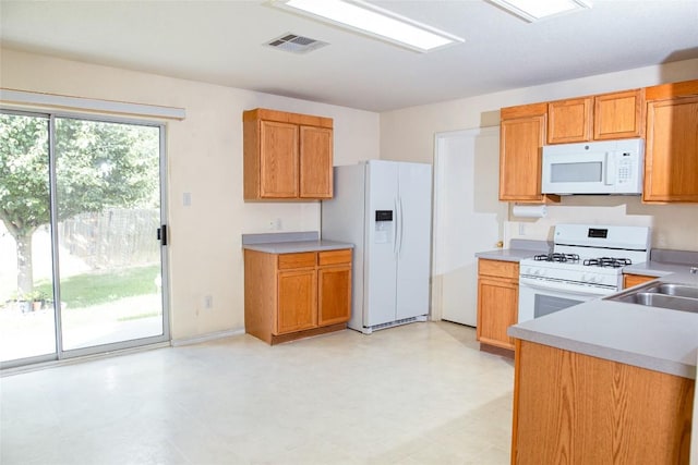 3807 Haleys Way, Round Rock, TX 78665 - kitchen featuring white appliances, light countertops, and brown cabinets