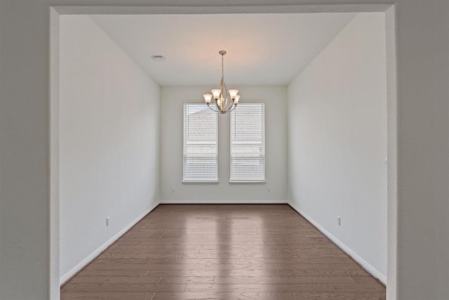 231 Prato Pl, Georgetown, TX 78628 - unfurnished room featuring dark wood-style flooring and a chandelier